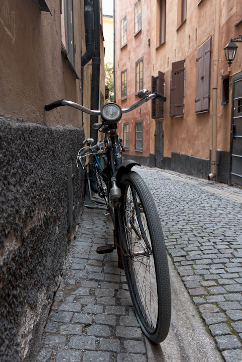 vintage bike leaning against a building wall