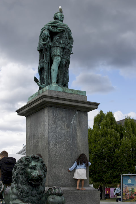 kid climbing an old statue